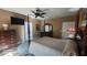 A bedroom featuring a four-poster bed, ceiling fan, carpet, and TV at 2719 Brookline Ave, New Smyrna Beach, FL 32168