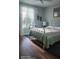 Bright bedroom featuring a large window, comfortable bed and hardwood floors at 2719 Brookline Ave, New Smyrna Beach, FL 32168