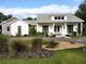 Charming home with well-maintained landscaping, white siding, and a welcoming front porch at 2719 Brookline Ave, New Smyrna Beach, FL 32168