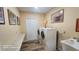 Neutral laundry room featuring a utility sink, countertop, and front-loading washer and dryer at 2719 Brookline Ave, New Smyrna Beach, FL 32168