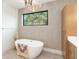 Relaxing bathroom featuring a soaking tub and stylish wall decor at 1018 Stetson St, Orlando, FL 32804