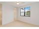 Bright bedroom with ceiling fan and large window at 1018 Stetson St, Orlando, FL 32804