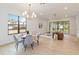 Bright dining area with a round table and gray chairs, adjacent to a living room at 1018 Stetson St, Orlando, FL 32804