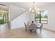 Open concept dining area with a round table and gray chairs near the entryway and staircase at 1018 Stetson St, Orlando, FL 32804