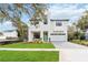 Two-story modern home with green door, paved driveway, and landscaped lawn at 1018 Stetson St, Orlando, FL 32804