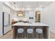 Modern kitchen with white and wood cabinets, quartz countertops and a gold range hood at 1018 Stetson St, Orlando, FL 32804