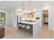 Modern kitchen with white cabinets, quartz countertops, and a kitchen island at 1018 Stetson St, Orlando, FL 32804