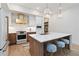 Modern kitchen with white and wood cabinets, quartz countertops and gold accents at 1018 Stetson St, Orlando, FL 32804