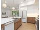 Modern kitchen with white and wood cabinets, quartz countertops and a farmhouse sink at 1018 Stetson St, Orlando, FL 32804