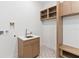 Bright laundry room with custom wooden cabinets and star patterned floor at 1018 Stetson St, Orlando, FL 32804