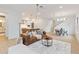 Open concept living room with brown leather sofa, looking toward the dining area and kitchen at 1018 Stetson St, Orlando, FL 32804