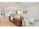 Open concept living room with brown leather sofa and a view of the entryway and dining area at 1018 Stetson St, Orlando, FL 32804