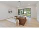 Living room with brown leather sofa and sliding glass doors to backyard at 1018 Stetson St, Orlando, FL 32804