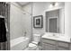 Clean bathroom with shower/tub combo, vanity, and gray tile at 1946 Quail Fields Cir, Winter Haven, FL 33884