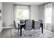 Elegant dining room with a dark wood table, gray chairs, and patterned curtains at 1946 Quail Fields Cir, Winter Haven, FL 33884