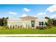 One-story home with light-colored siding, two-car garage, and landscaped lawn at 1946 Quail Fields Cir, Winter Haven, FL 33884