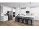 Modern kitchen with white cabinets, stainless steel appliances, and a large island at 1946 Quail Fields Cir, Winter Haven, FL 33884