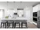 Modern kitchen featuring white cabinetry, stainless steel appliances, and an eat-in island at 1946 Quail Fields Cir, Winter Haven, FL 33884