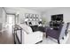 Living room with neutral color palette, comfortable seating, and a modern media cabinet at 1946 Quail Fields Cir, Winter Haven, FL 33884