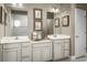 Double vanity bathroom with light cabinets and gray tile flooring at 1916 Quail Fields Cir, Winter Haven, FL 33884