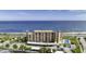 Stunning aerial view of oceanfront condo building with a pool, parking, and beautiful ocean views at 2390 Ocean Shore Blvd # 1040, Ormond Beach, FL 32176