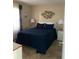 Well lit bedroom with a queen bed and decorative fish art at 2390 Ocean Shore Blvd # 1040, Ormond Beach, FL 32176