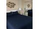 Cozy bedroom with a queen bed, mirrored closet, and decorative fish art at 2390 Ocean Shore Blvd # 1040, Ormond Beach, FL 32176