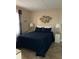 Comfortable bedroom with a queen bed and decorative fish art at 2390 Ocean Shore Blvd # 1040, Ormond Beach, FL 32176