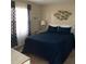 Inviting bedroom with a queen bed, fish art, and patterned curtains at 2390 Ocean Shore Blvd # 1040, Ormond Beach, FL 32176