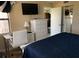 Bright bedroom features a desk, modern dresser, and flatscreen television at 2390 Ocean Shore Blvd # 1040, Ormond Beach, FL 32176
