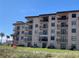 Multi-story condo building with multiple balconies and lush lawn at 2390 Ocean Shore Blvd # 1040, Ormond Beach, FL 32176