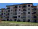 Multi-story condo building with multiple balconies and lush lawn at 2390 Ocean Shore Blvd # 1040, Ormond Beach, FL 32176