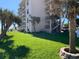 The exterior of the building features palm trees and well maintained lawn at 2390 Ocean Shore Blvd # 1040, Ormond Beach, FL 32176