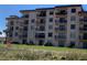 Multi-story condo building with multiple balconies and lush lawn at 2390 Ocean Shore Blvd # 1040, Ormond Beach, FL 32176