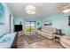 Comfortable living room with tile floors, modern lighting, and a sliding glass door to the outdoors at 2390 Ocean Shore Blvd # 1040, Ormond Beach, FL 32176