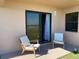 Covered patio with chairs and water views visible through sliding glass door at 2390 Ocean Shore Blvd # 1040, Ormond Beach, FL 32176