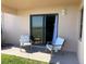 A relaxing patio with sliding glass doors and comfortable chairs invites you to unwind at 2390 Ocean Shore Blvd # 1040, Ormond Beach, FL 32176