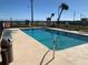 Community pool area with clear blue water with plenty of seating and ocean view at 2390 Ocean Shore Blvd # 1040, Ormond Beach, FL 32176