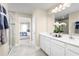 Bright bathroom with double vanity, shower, and bedroom access at 3025 Ruby Falls Dr, Deland, FL 32724