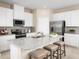 Modern kitchen with white cabinets, granite countertops, and stainless steel appliances at 3025 Ruby Falls Dr, Deland, FL 32724