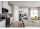 Modern kitchen with white cabinets, granite countertops, and island at 3025 Ruby Falls Dr, Deland, FL 32724