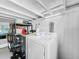 Laundry room with washer, dryer, and storage shelving at 104 Sunset Way, Fruitland Park, FL 34731