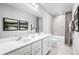 Bathroom with double vanity, soaking tub, and neutral tile at 1202 Whispering Ln, Minneola, FL 34715