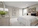 Light and airy bedroom with a bed, dresser, and neutral decor at 1202 Whispering Ln, Minneola, FL 34715