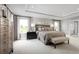 Spacious main bedroom with large windows and en-suite bathroom at 1202 Whispering Ln, Minneola, FL 34715