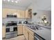 Well-organized kitchen featuring stainless steel appliances, tile backsplash, and ample counter space at 2639 Maitland Crossing Way # 305, Orlando, FL 32810