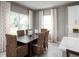 Bright dining room featuring a wood table and wicker chairs, with large windows at 2105 Aibonito Cir, Clermont, FL 34711