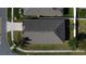 Aerial view of the home's roof, sidewalks, street and adjacent landscaping and residences at 2588 Egret Loop, Kissimmee, FL 34743