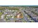 Birds eye view of a community of single-Gathering homes, featuring a peaceful street, green lawns and mature trees at 2588 Egret Loop, Kissimmee, FL 34743