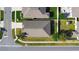 An overhead view of a home with manicured lawn and lush landscaping, surrounded by a sidewalk and quiet neighborhood at 2588 Egret Loop, Kissimmee, FL 34743